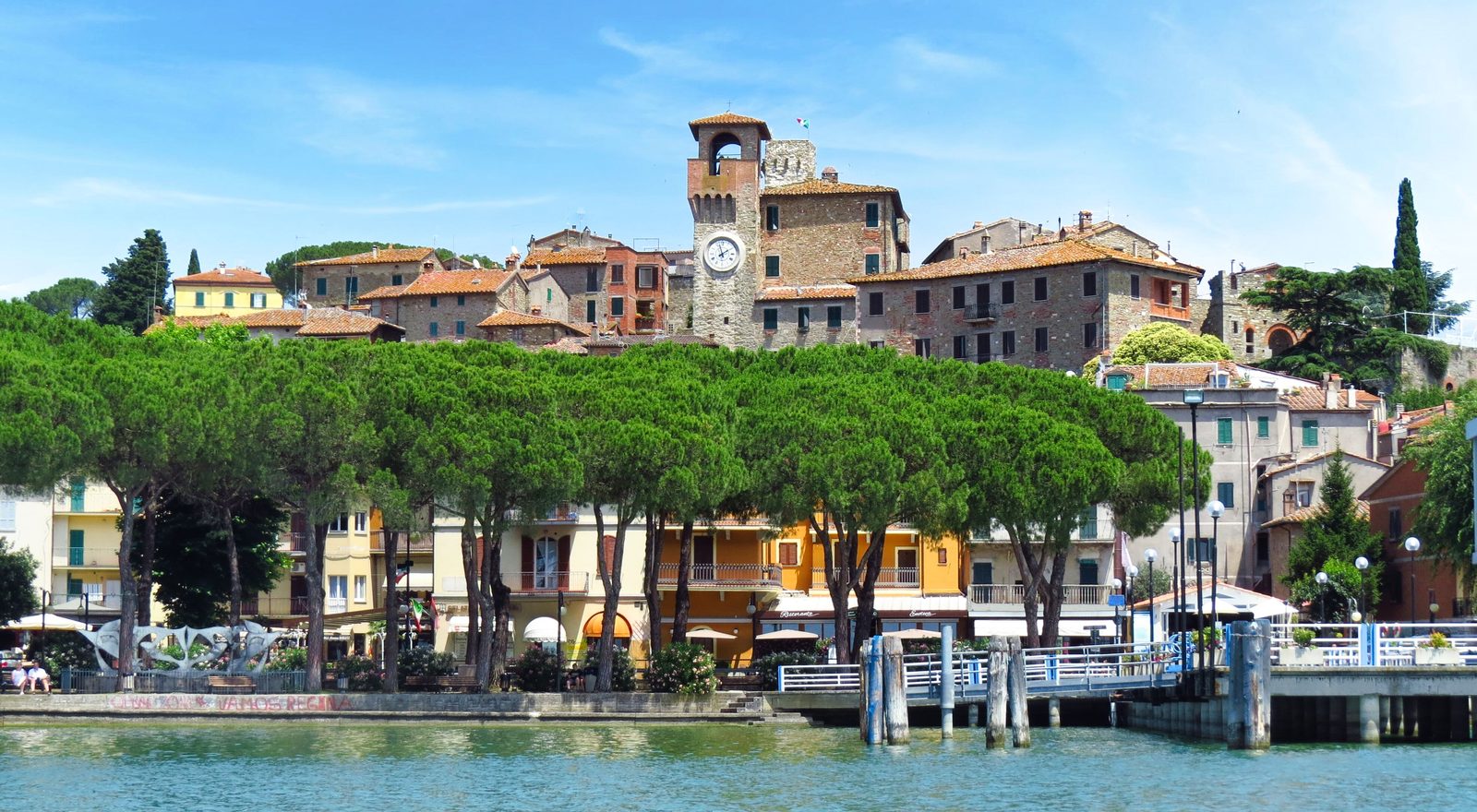 Passignano sul Trasimeno seen from the lake, with its medieval tower above the waterfront