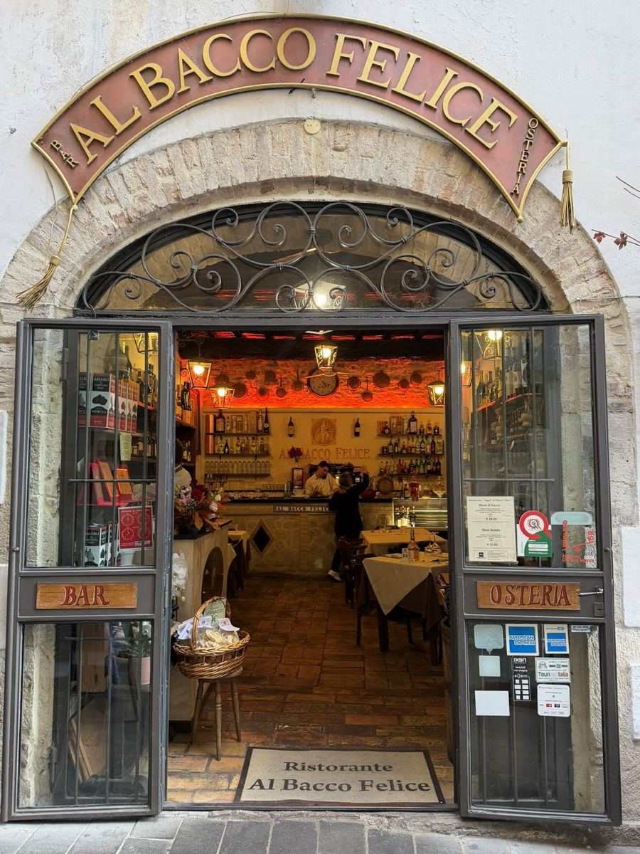 The arched entrance of Al Bacco Felice osteria in Spoleto