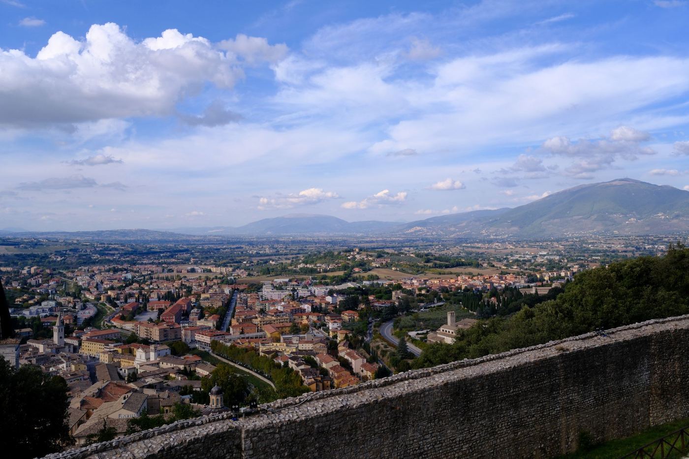 View from Spoleto's upper town across the rooftops to the Valle Umbra and distant mountains